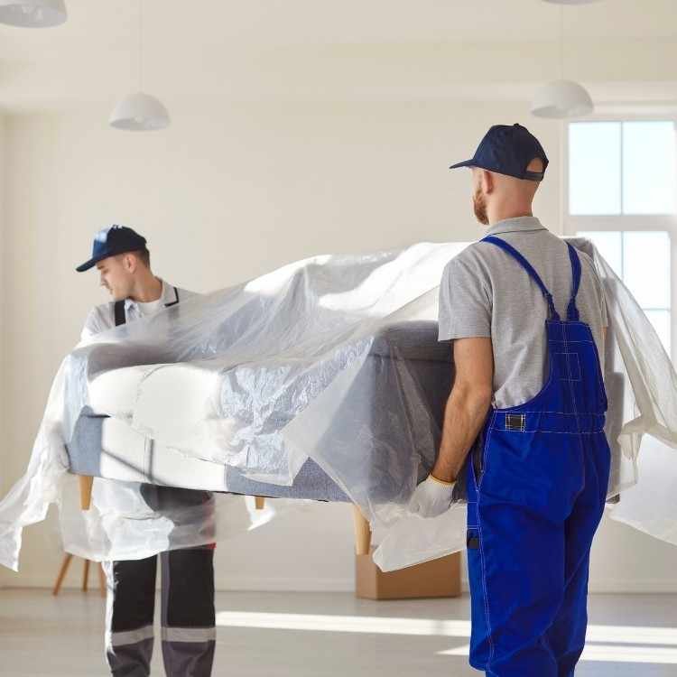 Skilled movers and packers in Dubai wrapping fragile items securely